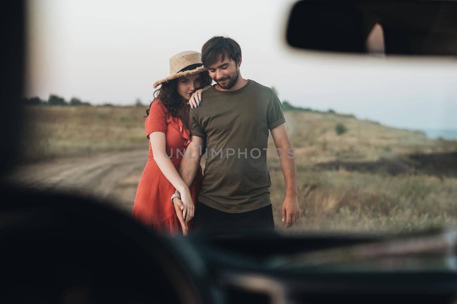 View Through Front Window of Car, Young Couple Man and Woman Having Fun Time Together Outdoors Near Sea