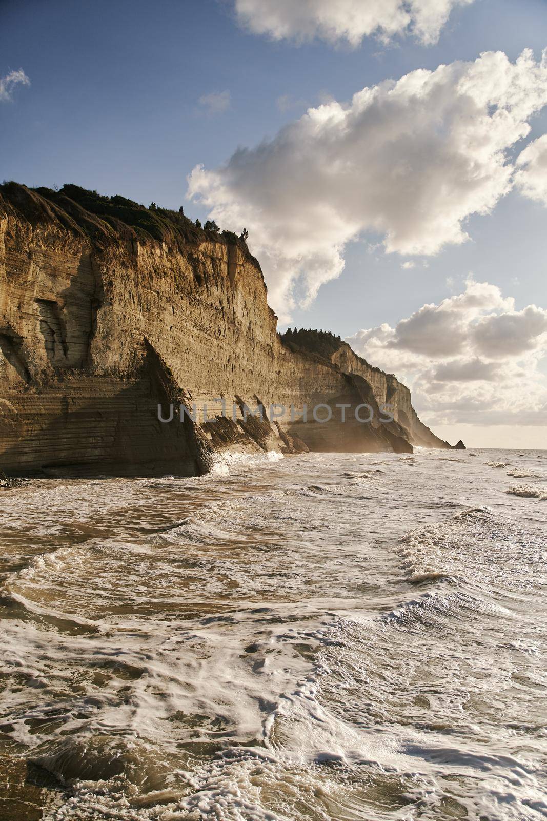 View of Logas Beach and the amazing rocky cliff in Peroulades. Corfu island. Greece.