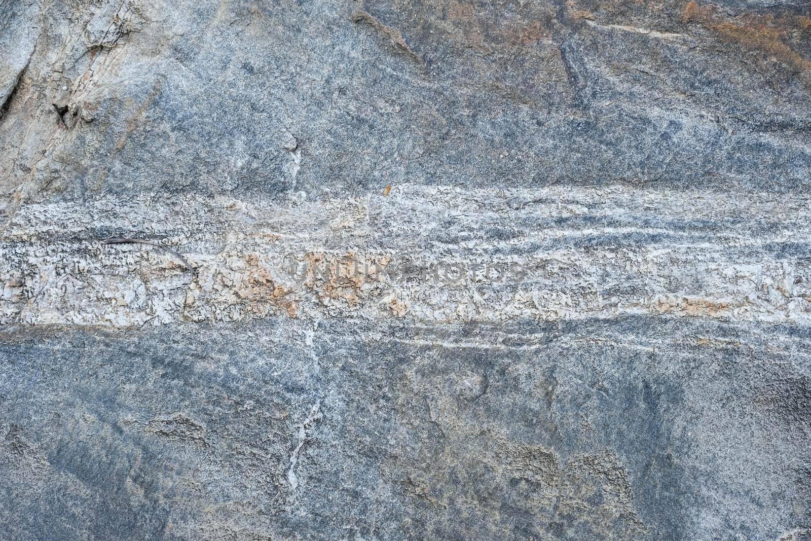 Close-up texture of a natural river bank stone wall in a mountain forest in northern Thailand. Stone and ecology concept.