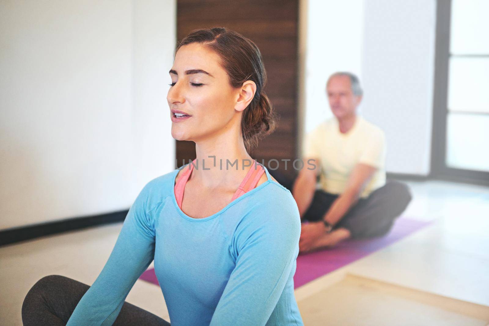 Cropped shot of a yoga instructor guiding a senior man in a yoga class.