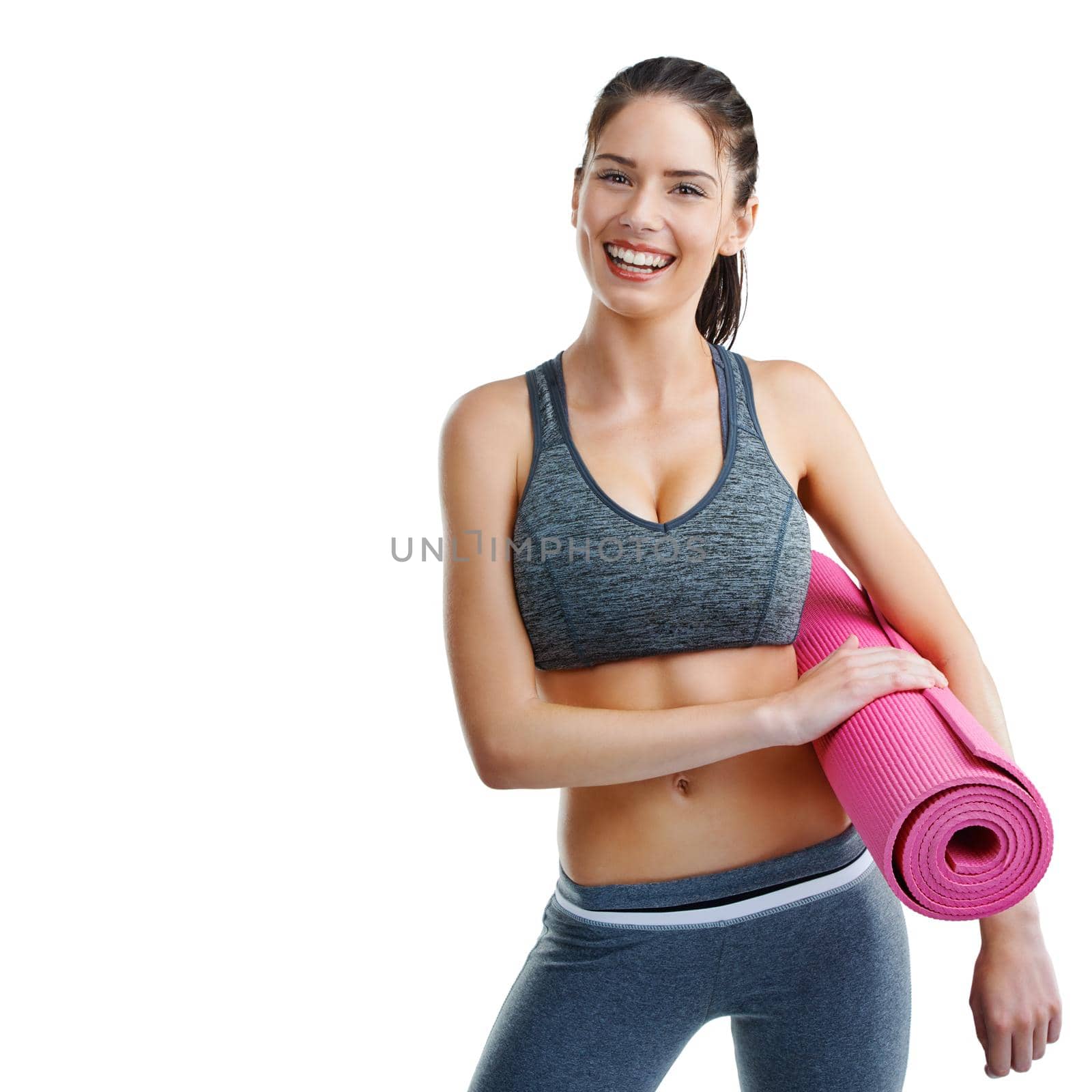 Studio shot of a fit young woman holding an exercise mat isolated on white.