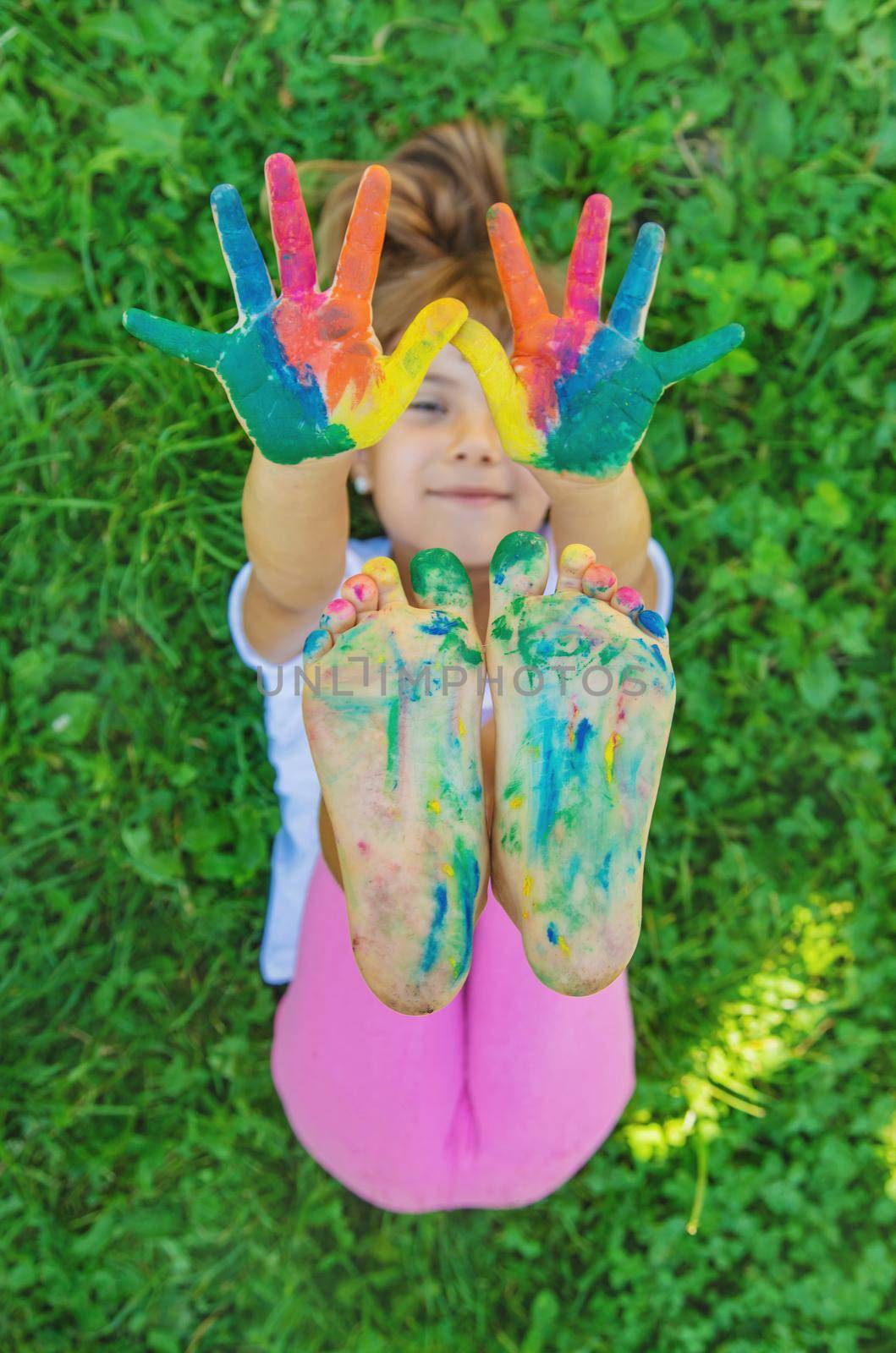 child with painted hands and legs. Selective focus.