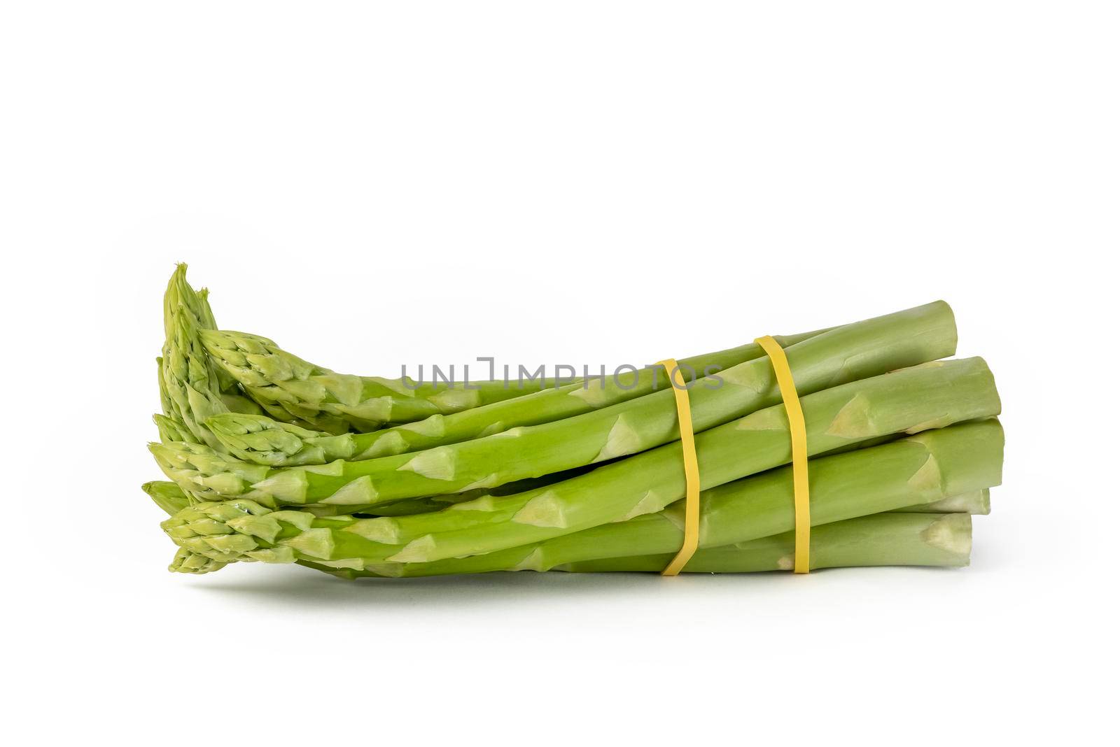Bunch of fresh green asparagus isolated on white background. Freshly picked asparagus with water drops isolated on white background. by SERSOL