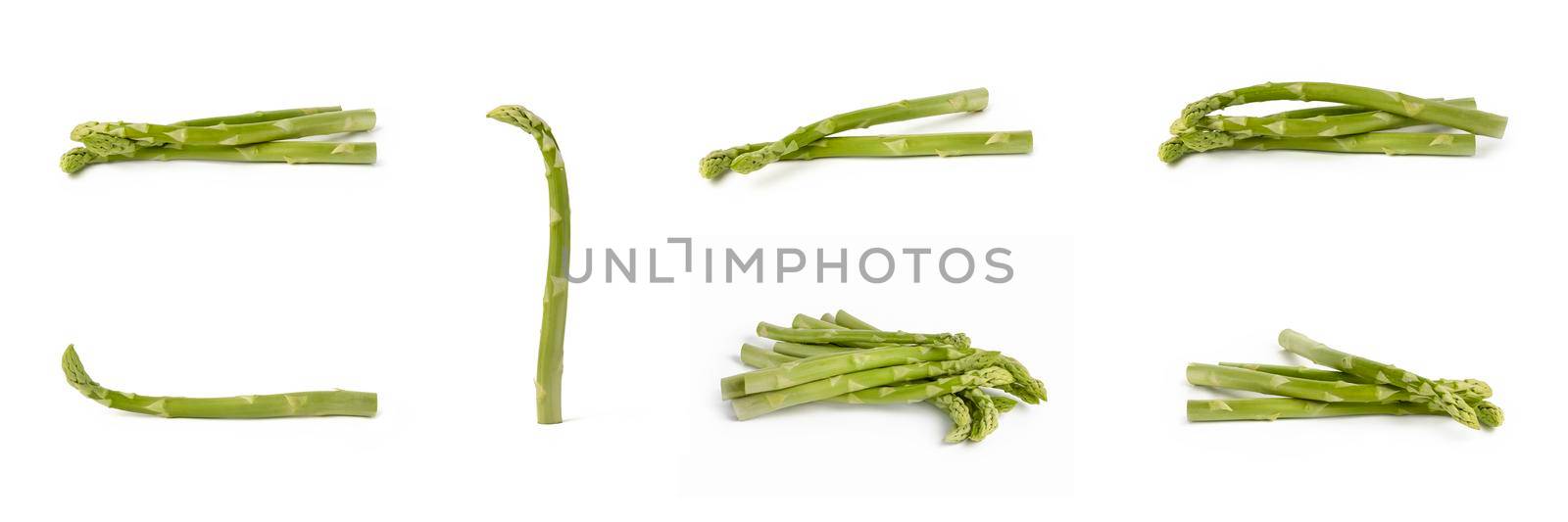 Bunch of fresh green asparagus isolated on white background. Big set freshly picked asparagus with water drops isolated on white background
