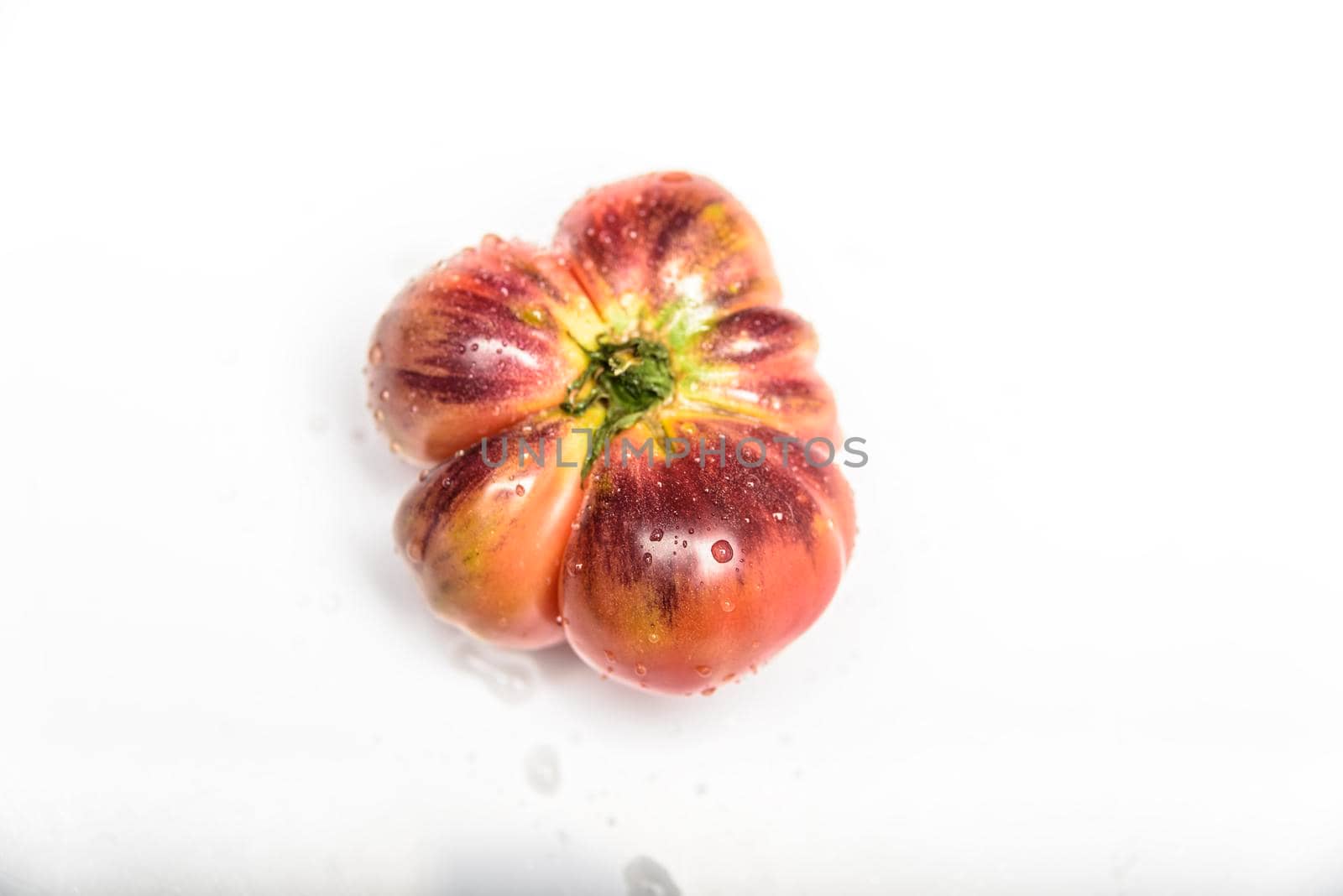 Green Tiger tomatoes isolated on white, top view