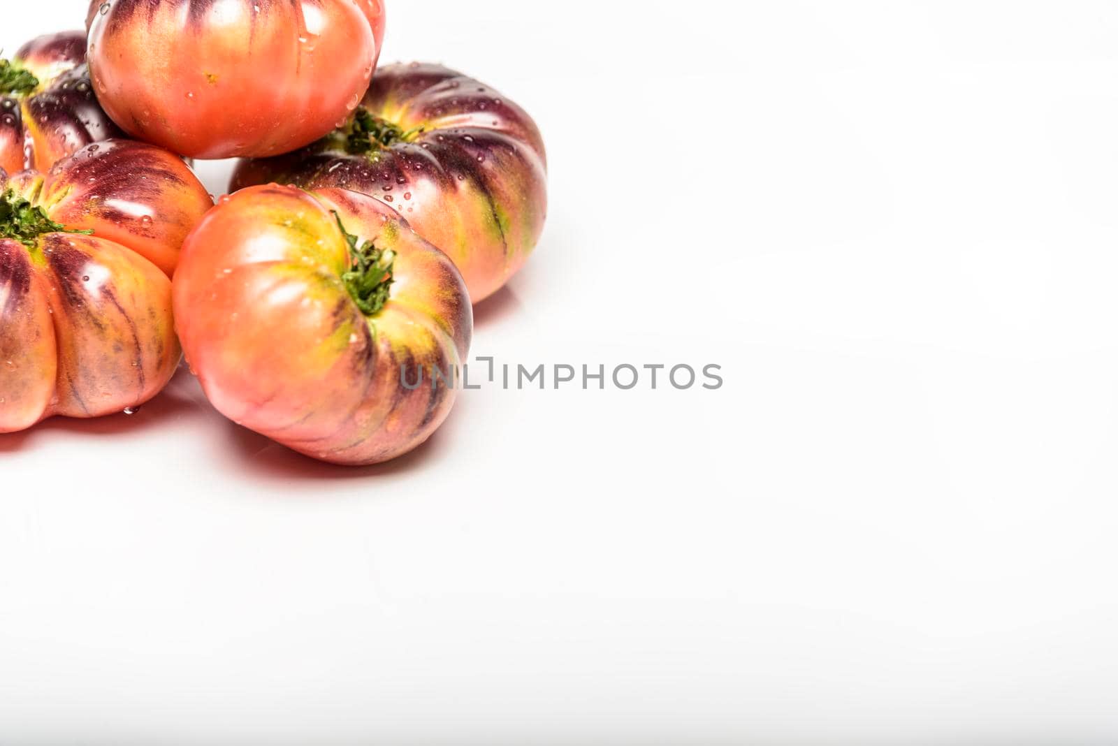 Green Tiger tomatoes isolated on white, top view