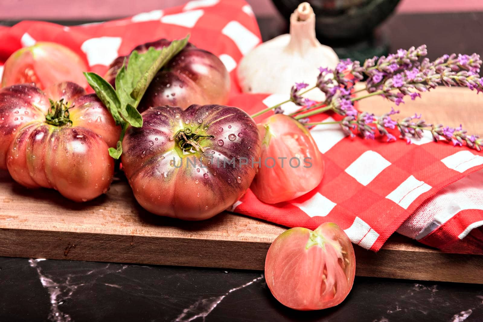 Fresh tomatoes in a plate on a dark background. Harvesting tomatoes. Top view