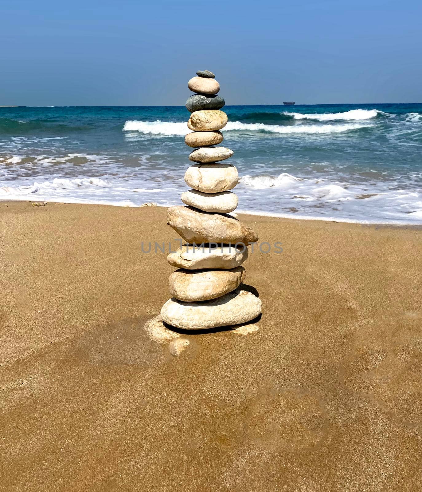 Zen meditation relaxation concept background - balanced stones stack close up on sea beach. High quality photo