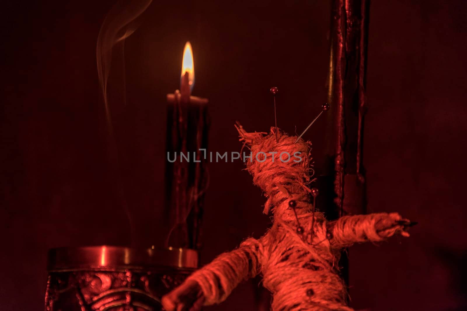 Voodoo Doll on a wooden background with dramatic lighting