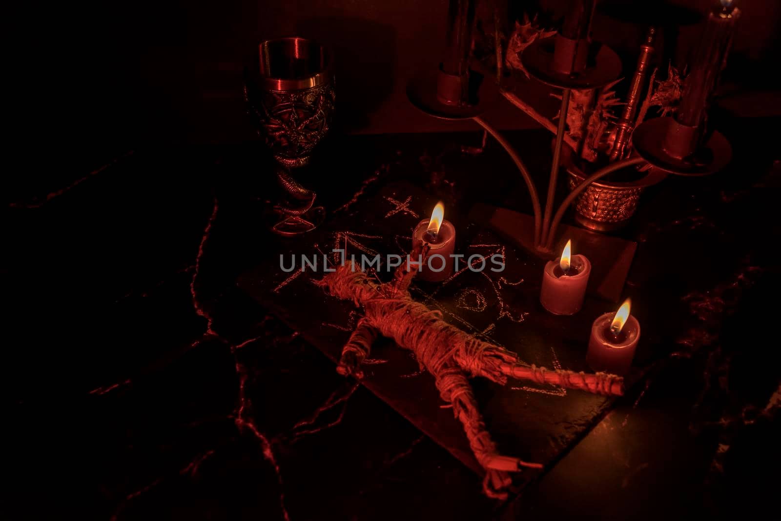 Voodoo Doll on a wooden background with dramatic lighting