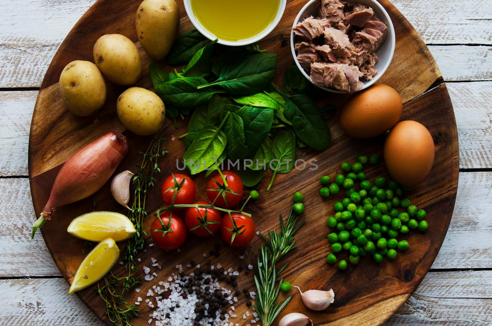 Fresh vegetables and ingredients for cooking tuna salad on the wooden. Dark colors.