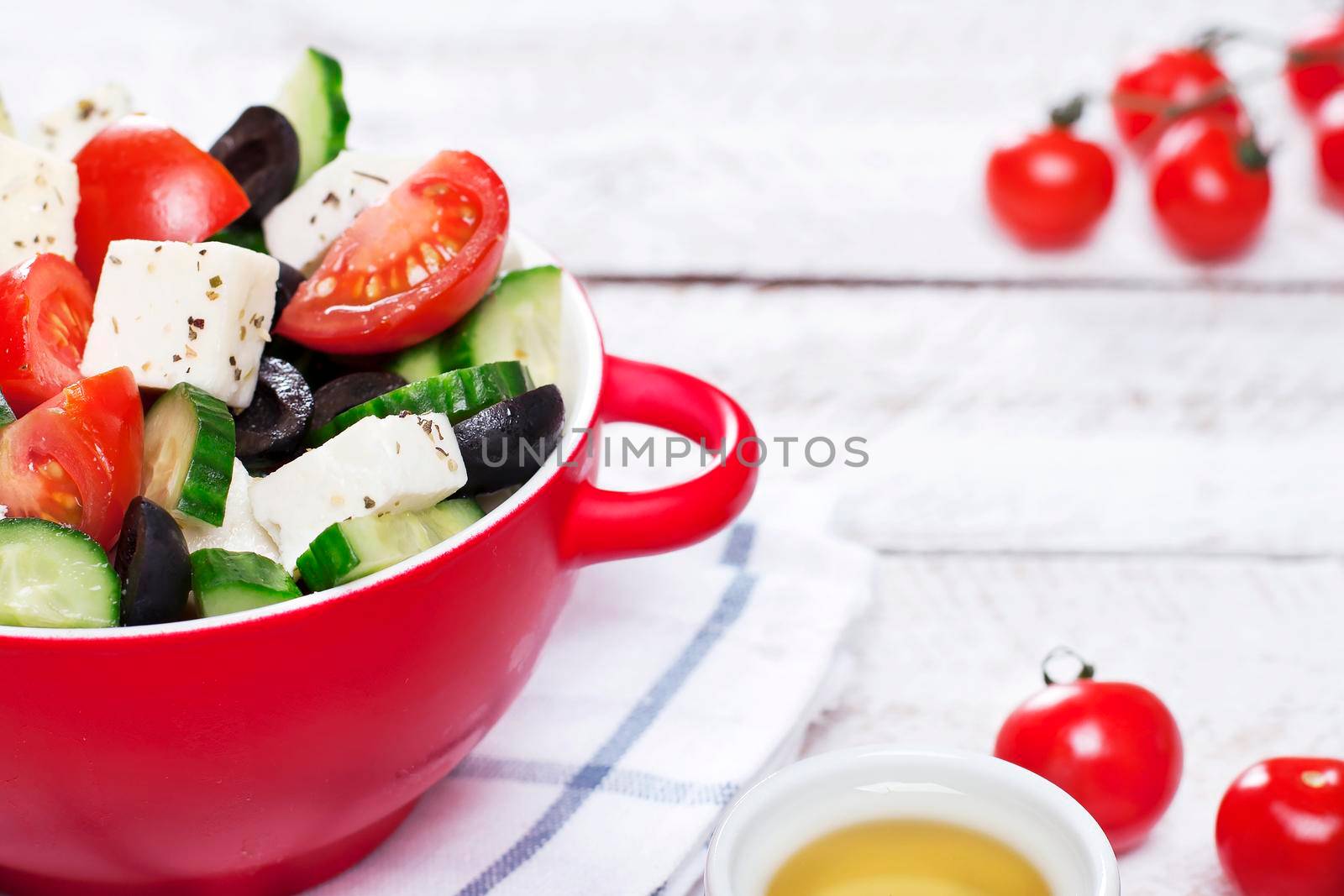 Greek salad in red boul and copy space - Stock image