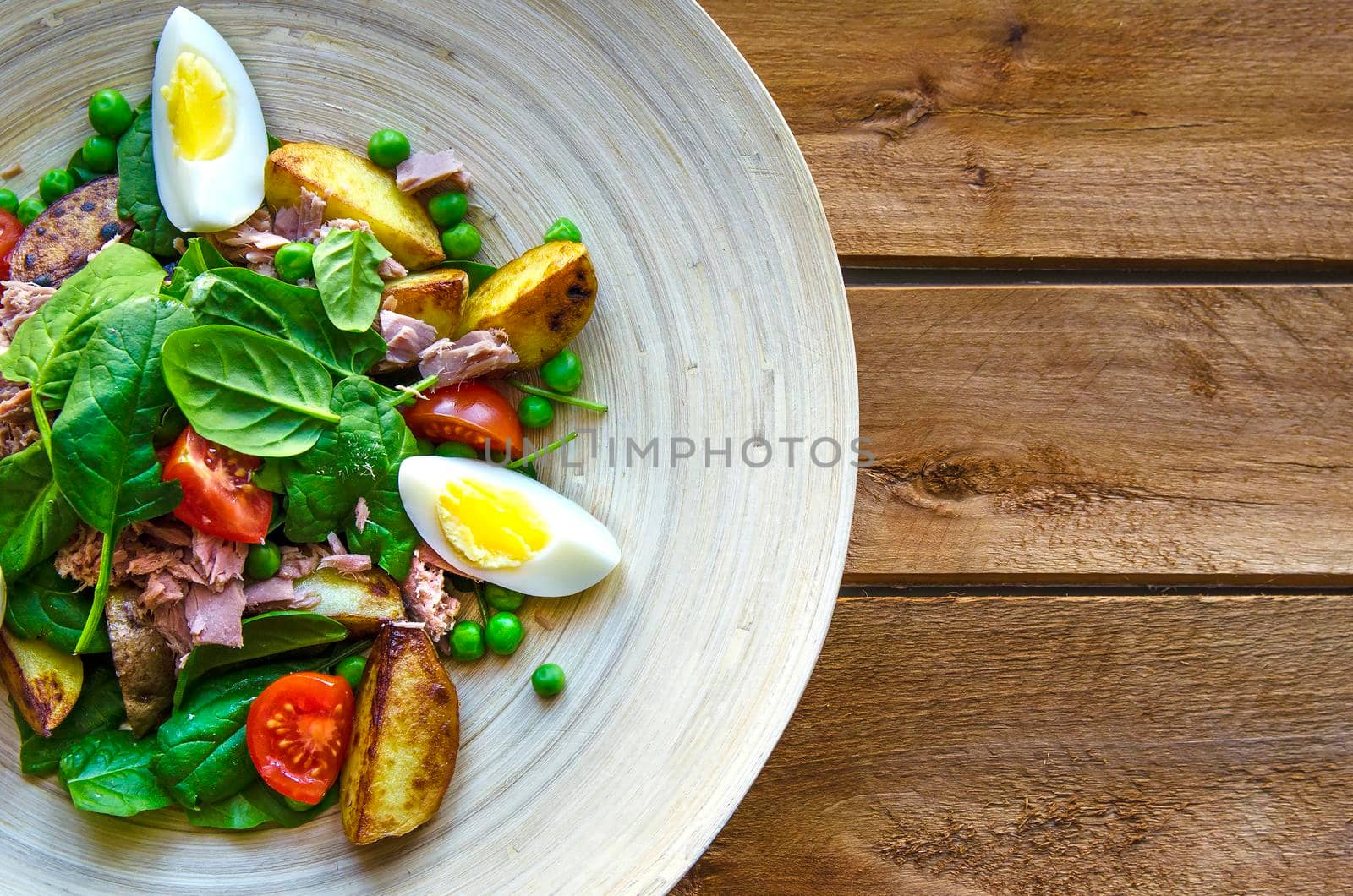 Cooking tuna salad on the wooden plate. Stock image.