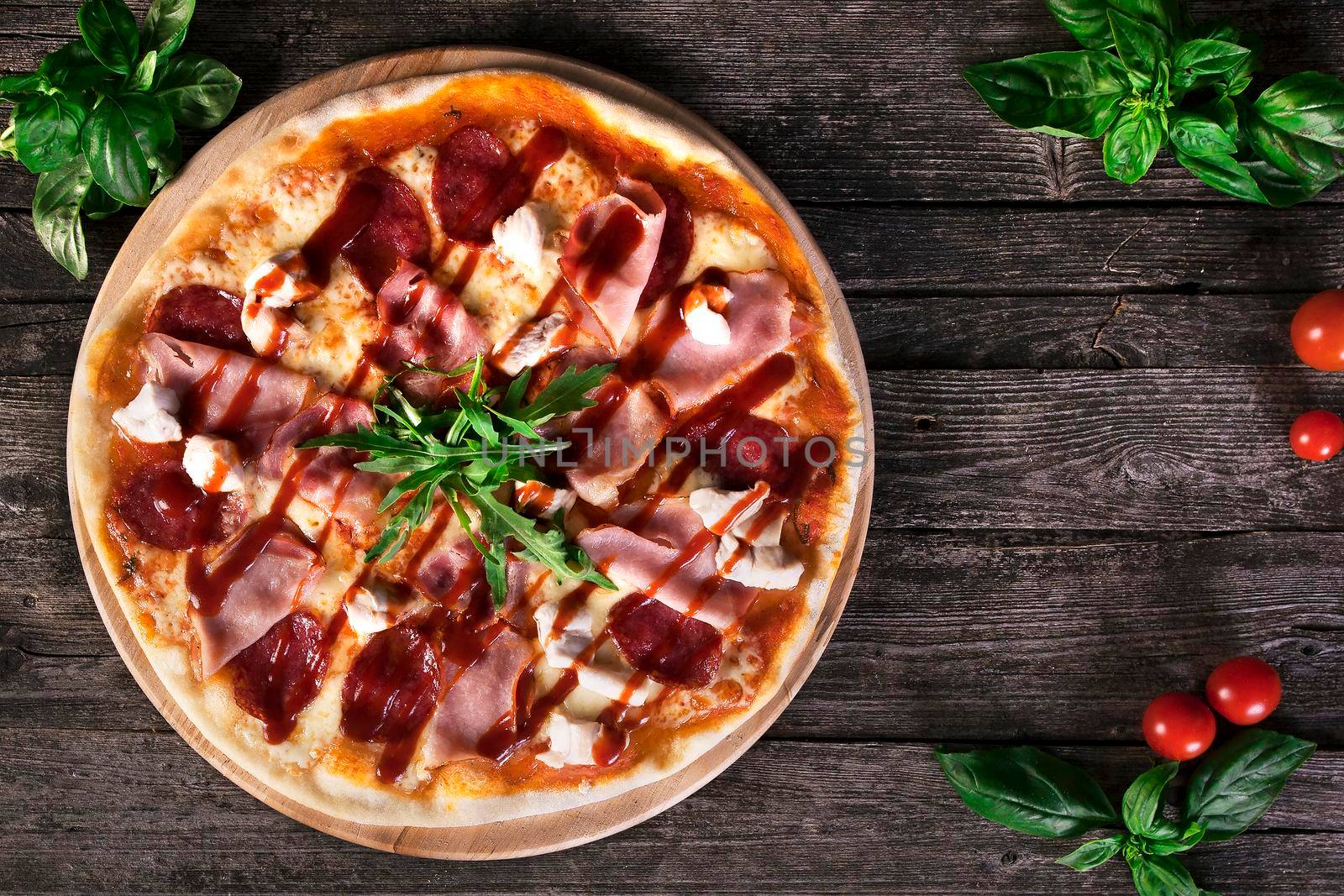 Delicious fresh Pizza with bacon and tomato paste on the wooden background. Top view.