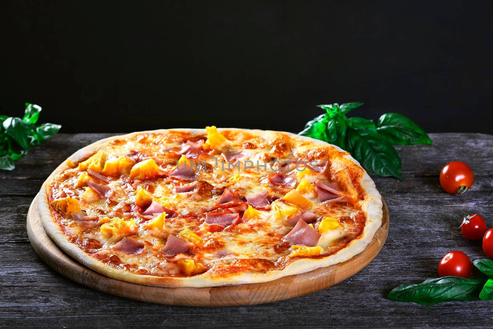 Delicious fresh Pizza with pineapple, bacon and cheese mozzarella on the wooden. Top view.