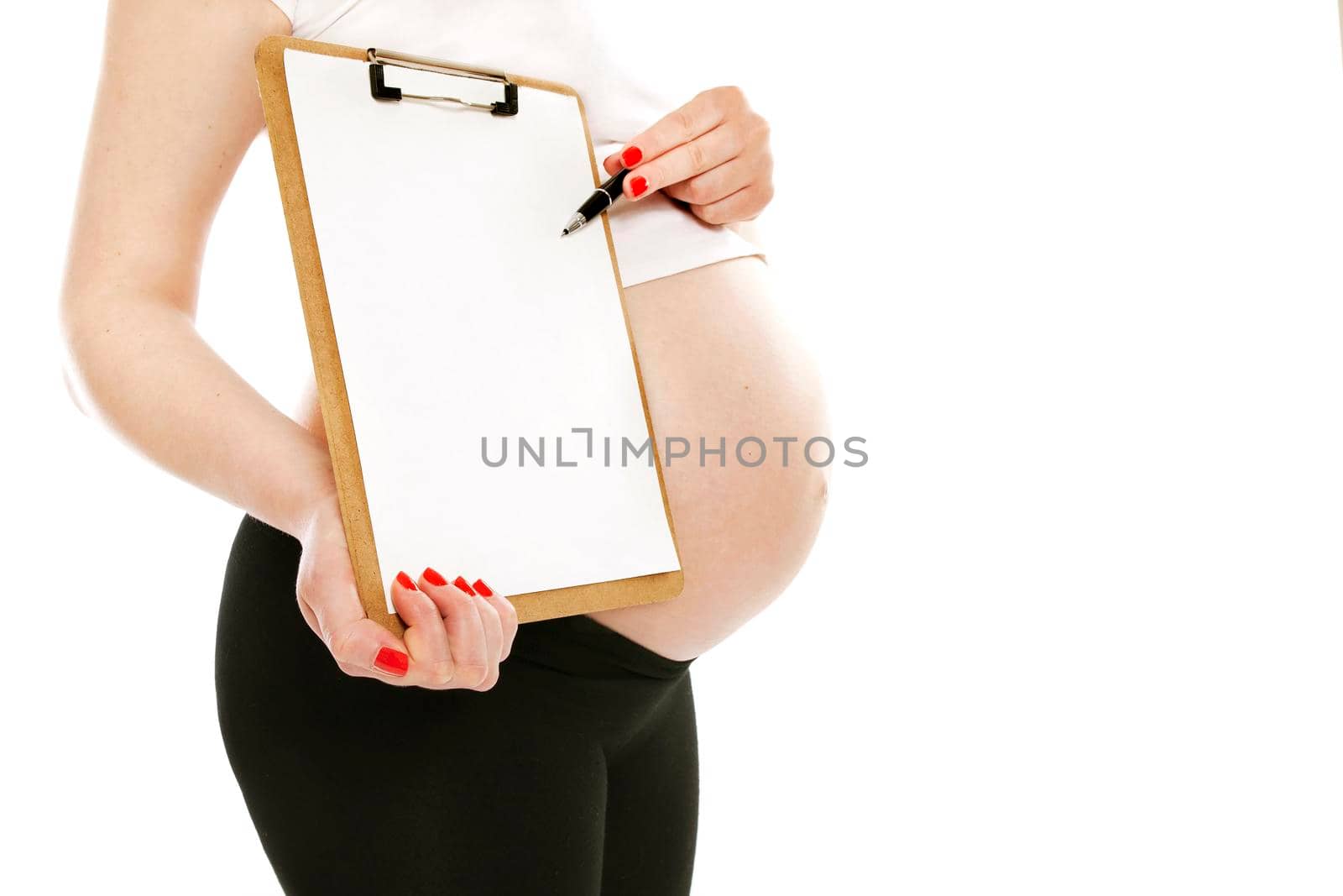 Beautiful young pregnant woman showing folder or tablet with blank white screen for copy space or advertising area