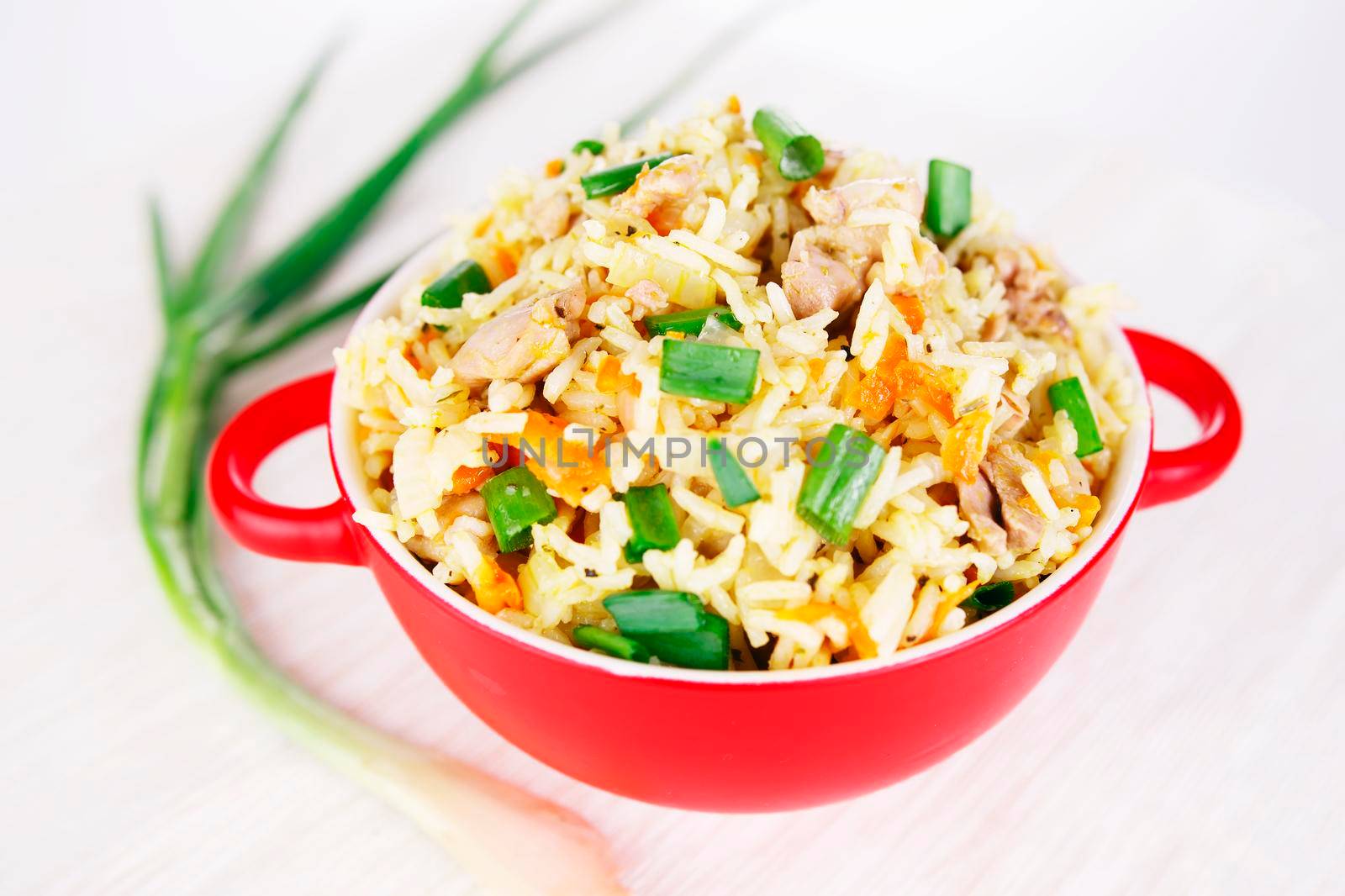 Fragrant Pilau Pulav pilaf pilaf, fried rice with meat and vegetables on a grey plate. Isolated on white. Macro.