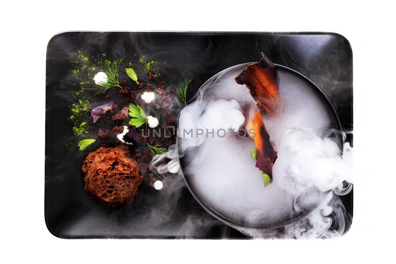 Culinary abstraction. Molecular Cuisine. Delicious modern soup with beetroot. Isolated on white. Stock image.