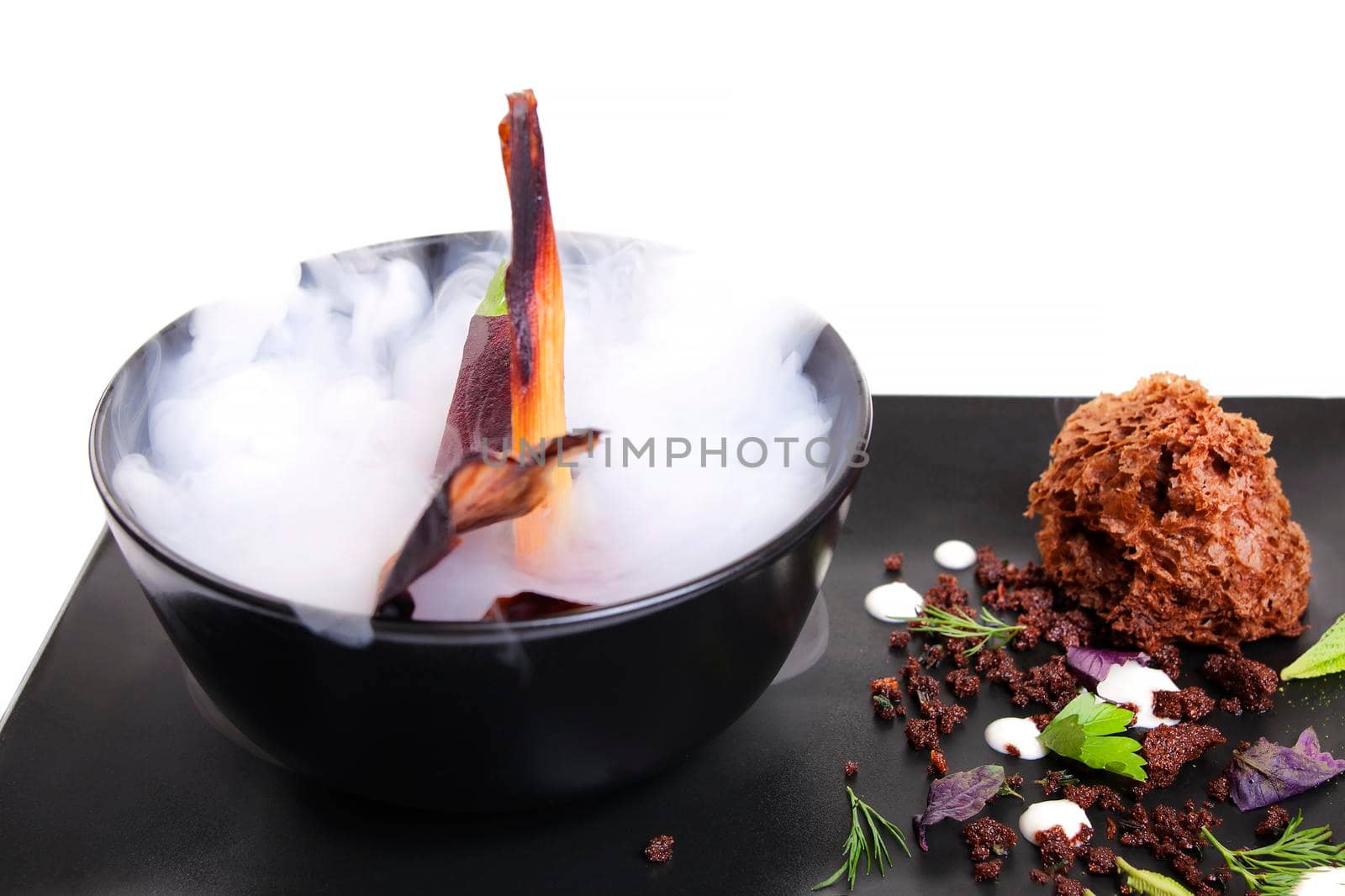 Molecular Cuisine. Delicious modern soup with beetroot. Isolated on white. Stock image.