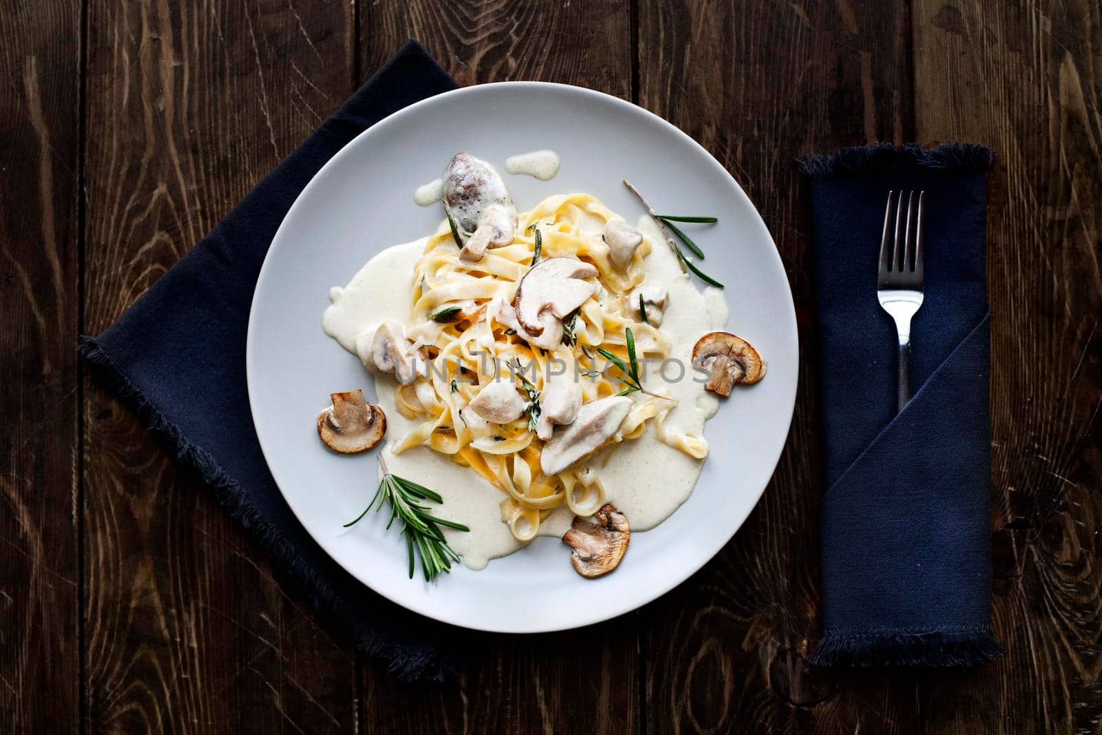 Tagliatelle vegetarian Pasta Dish with Mushrooms on the wooden background - Stock image