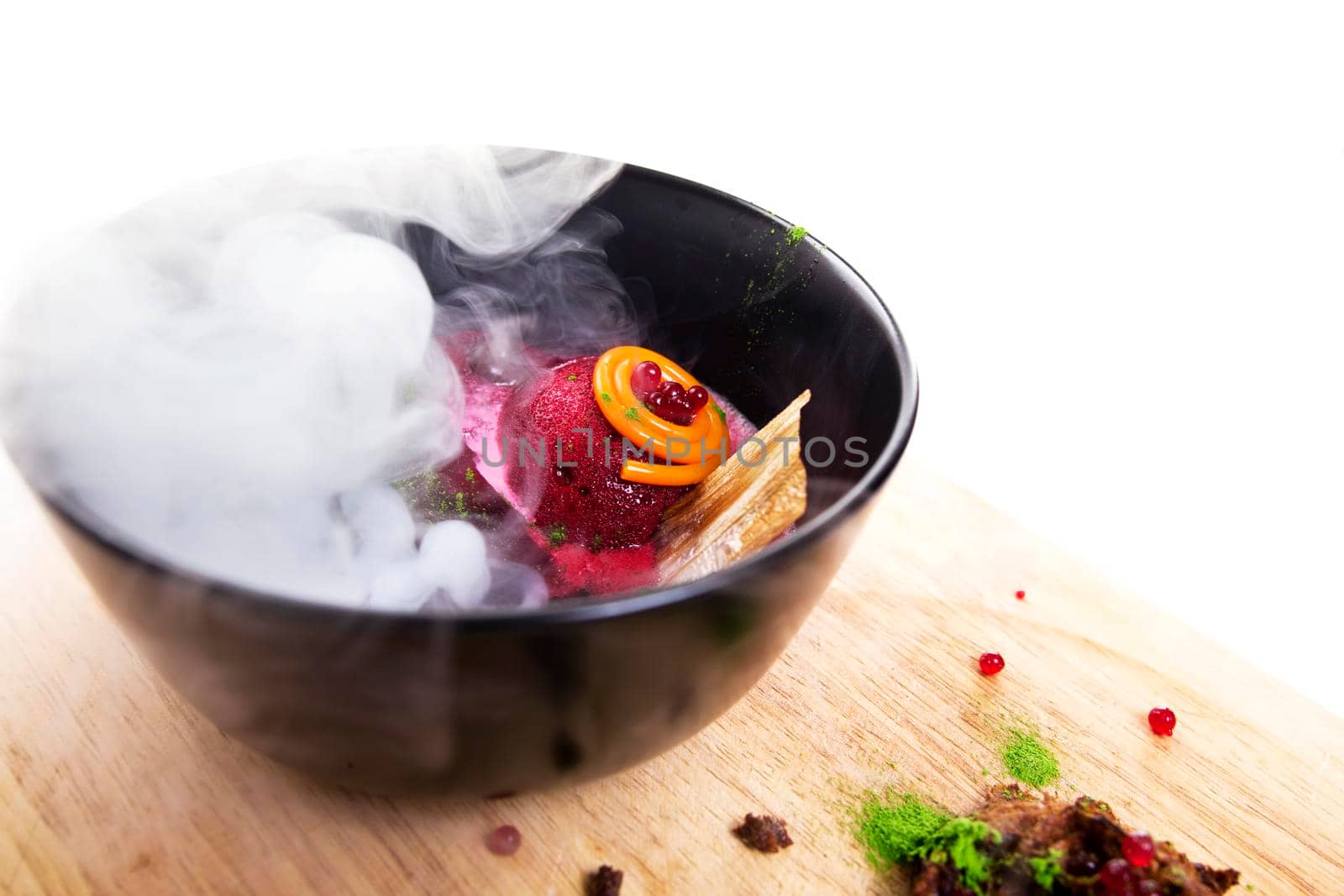 Molecular Cuisine. Delicious modern soup with beetroot. Isolated on white. Stock image.