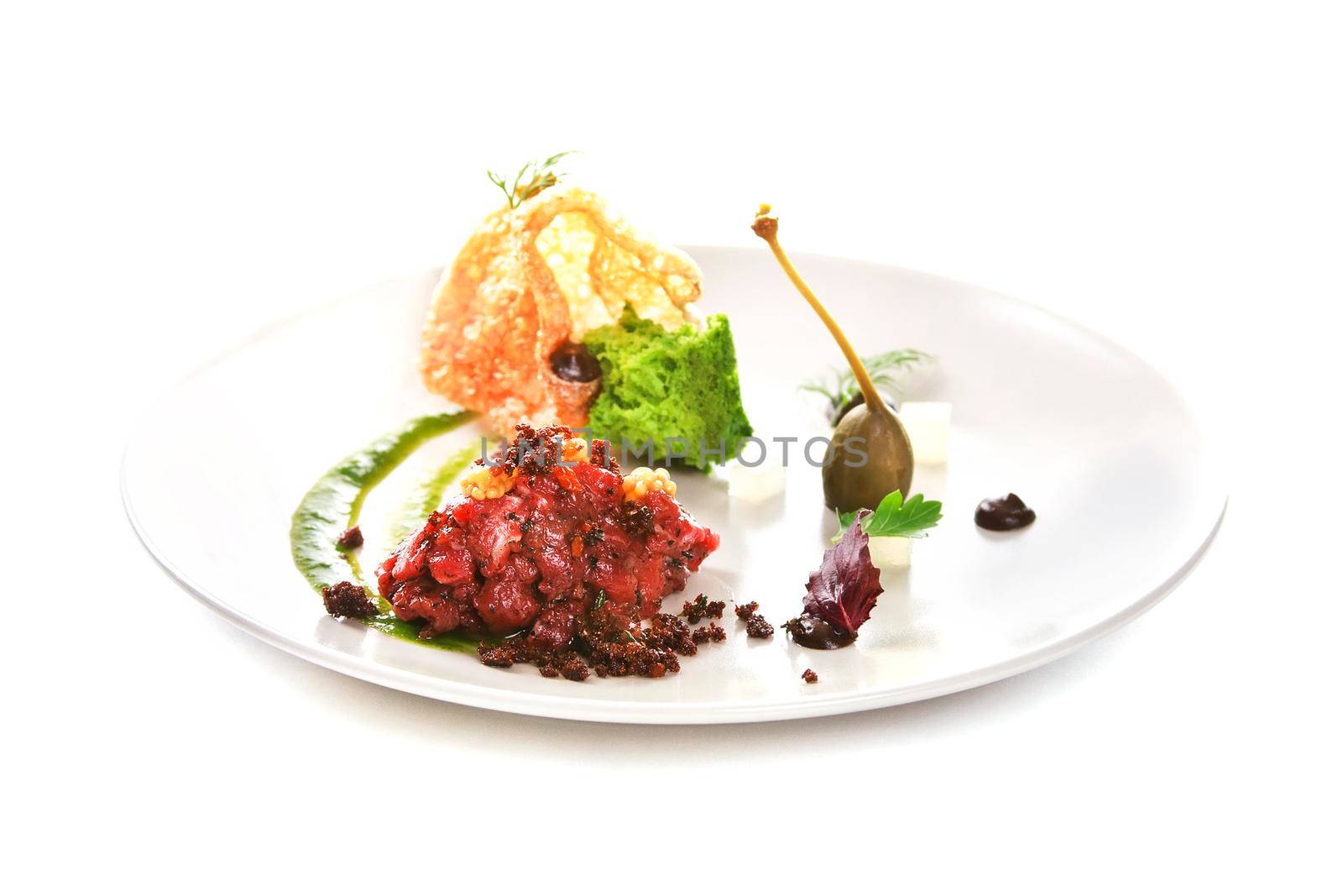 Molecular modern cuisine. Chips Pigskin with tartare or carpaccio of beef. Stock image. Isolated on white.