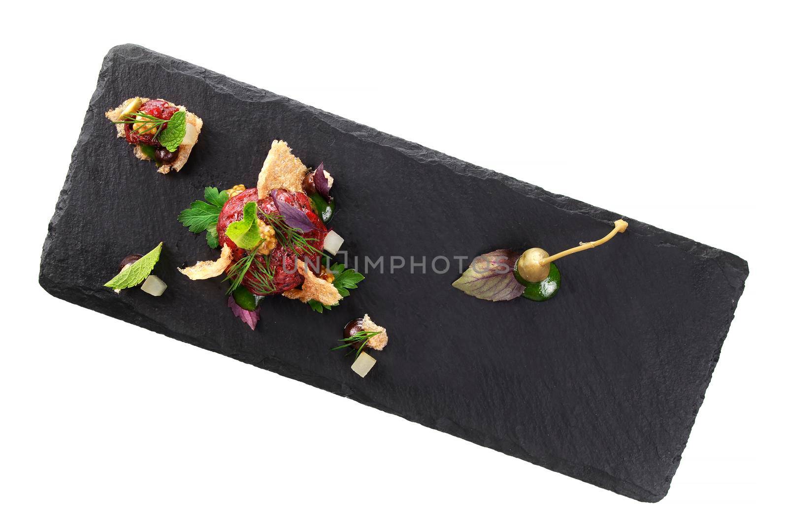 Molecular modern cuisine. Chips Pigskin with tartare or carpaccio of beef. Stock image. Isolated on white.