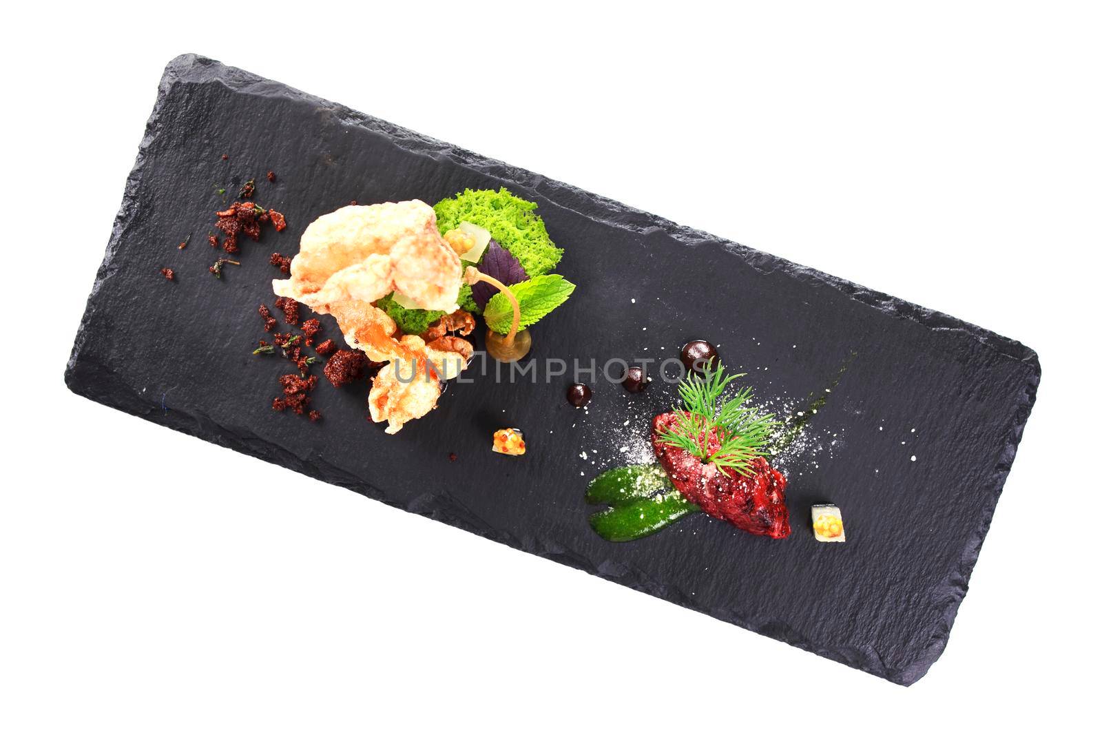 Molecular modern cuisine. Chips Pigskin with tartare or carpaccio of beef. Stock image. Isolated on white.