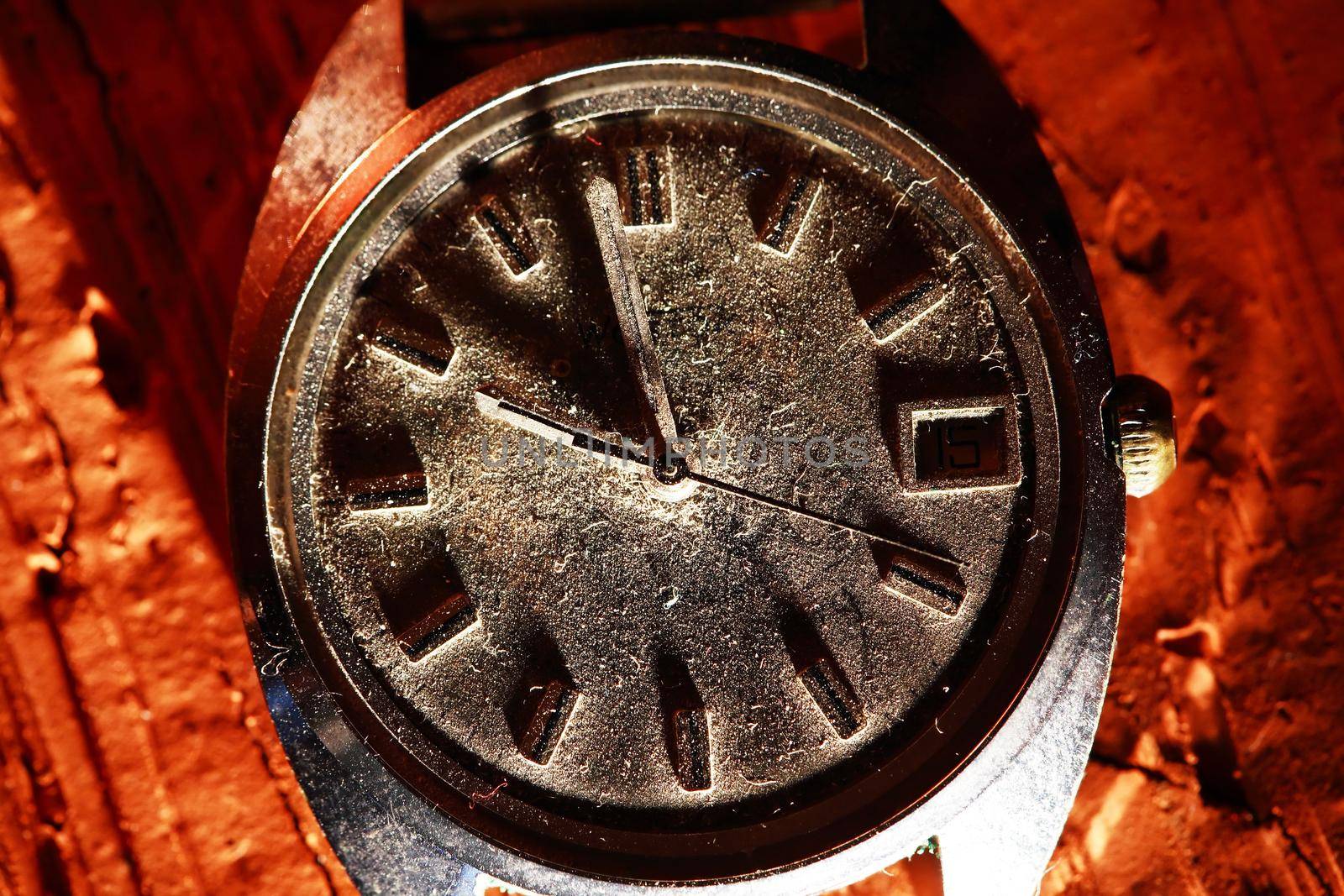 Time concept. Extreme closeup of very old wristwatch with dust