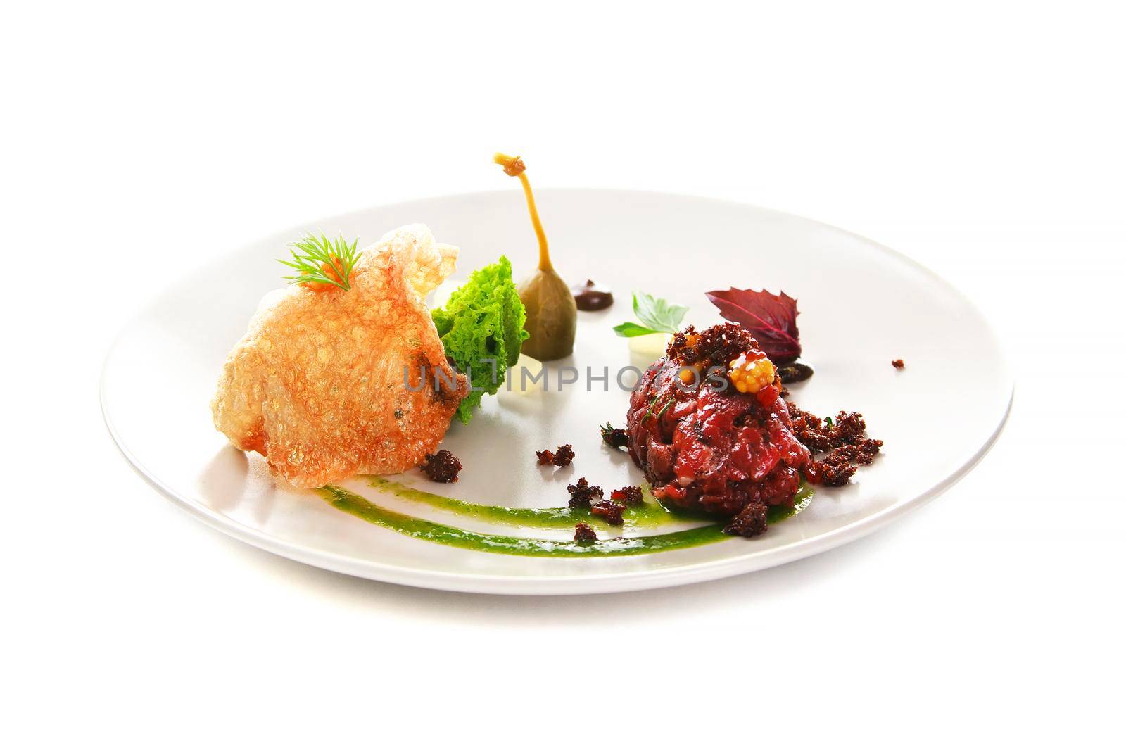 Molecular modern cuisine. Chips Pigskin with tartare or carpaccio of beef. Stock image. Isolated on white.