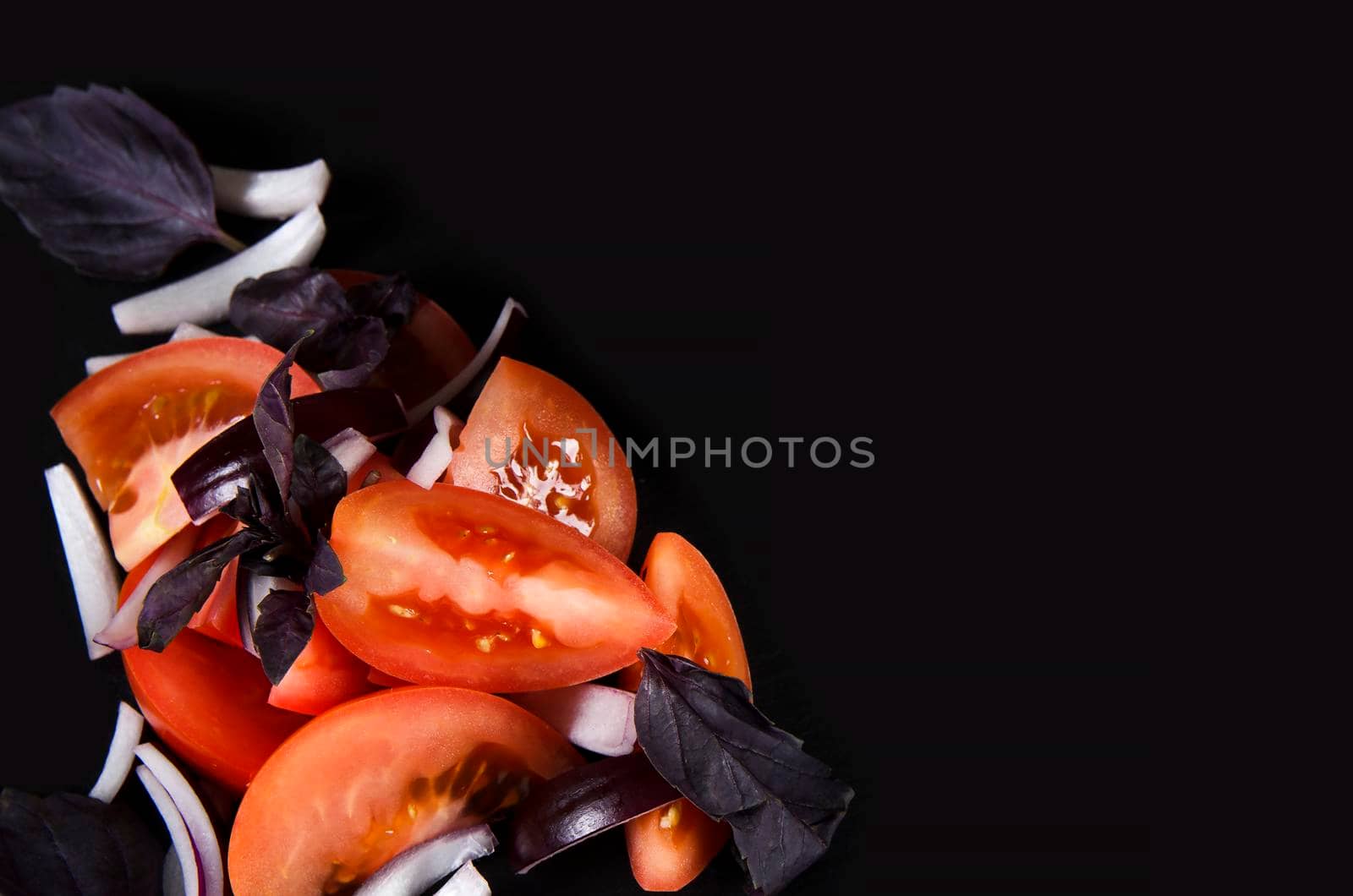 Slices of tomato. Vegetables on Black background with copy space