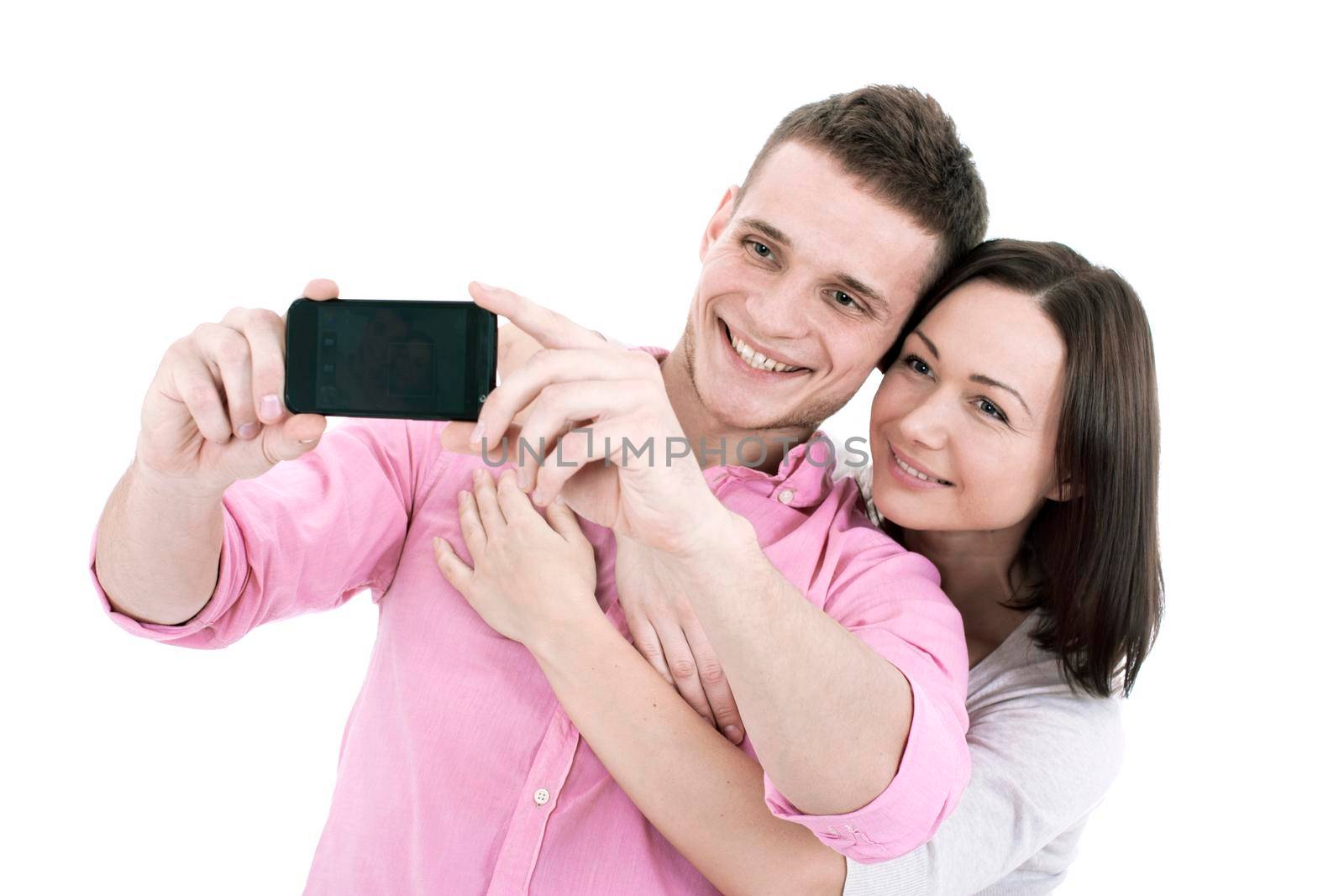 Attractive young couple taking a selfie together, isolated on white
