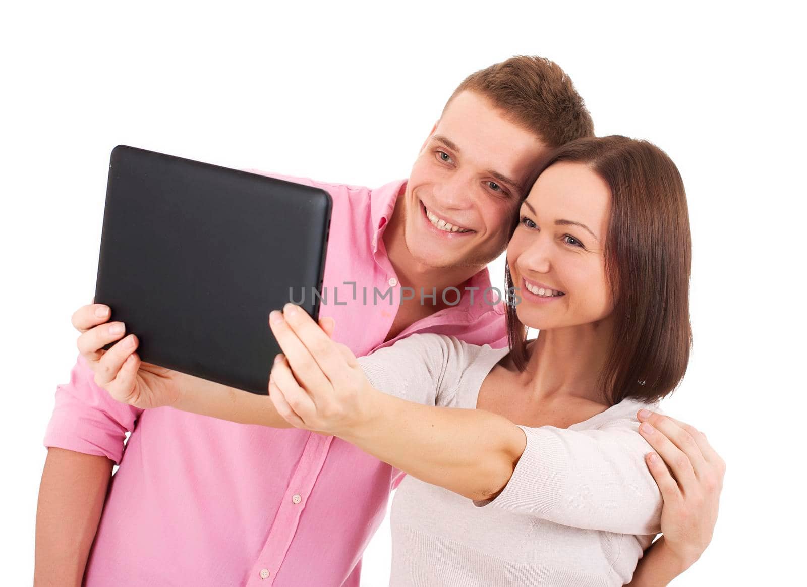 Attractive young couple taking a selfie together - Stock Image by Jyliana