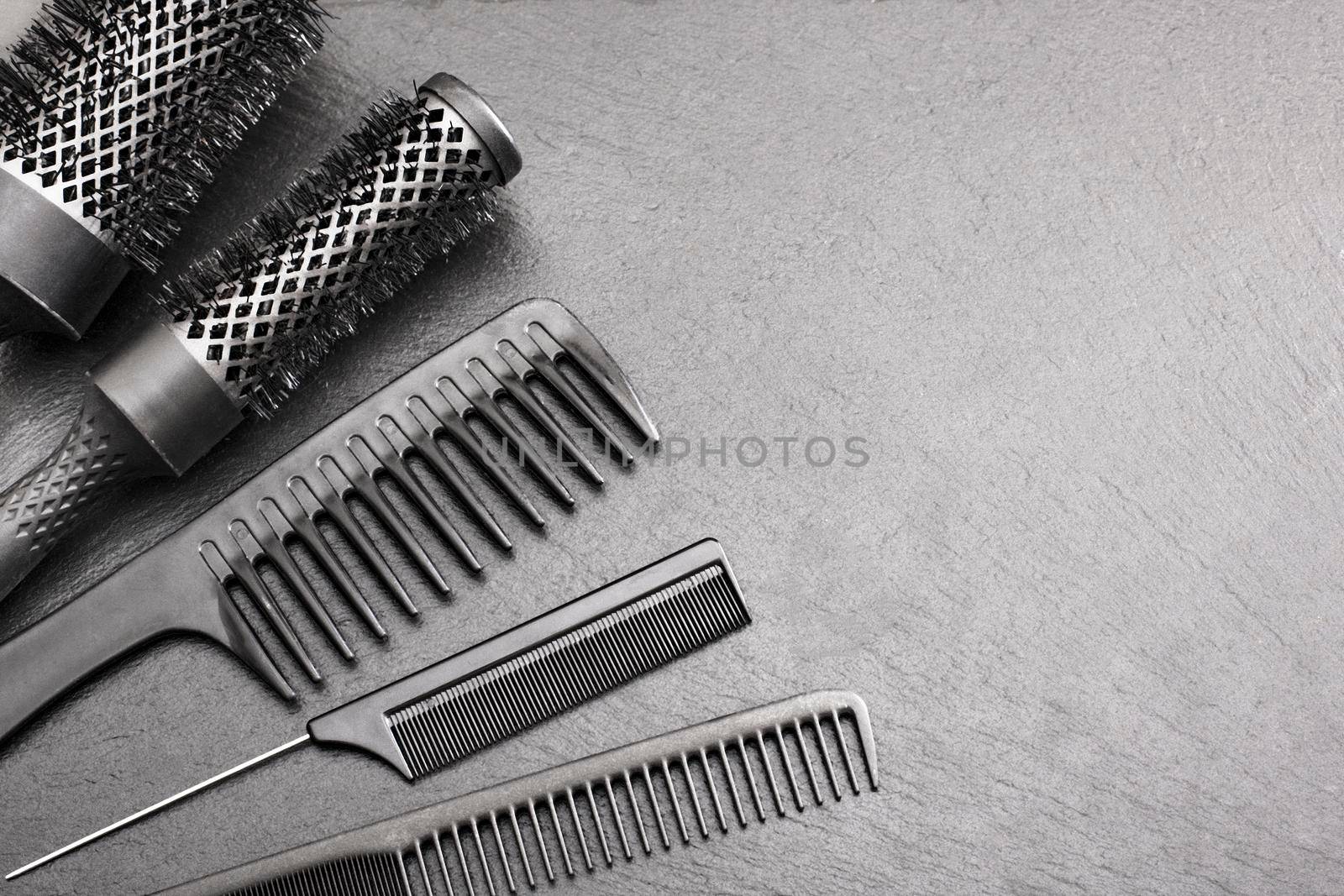 Salon Hairdresser Accessories, Comb and brashing for cutting hair on a black background