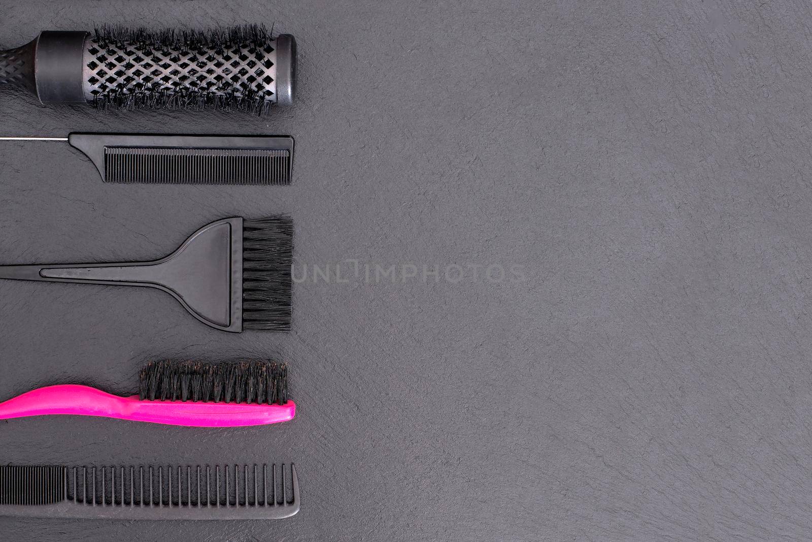 Salon Hairdresser Accessories, pink Comb, application brush, brashing for cutting hair or colored on a black background