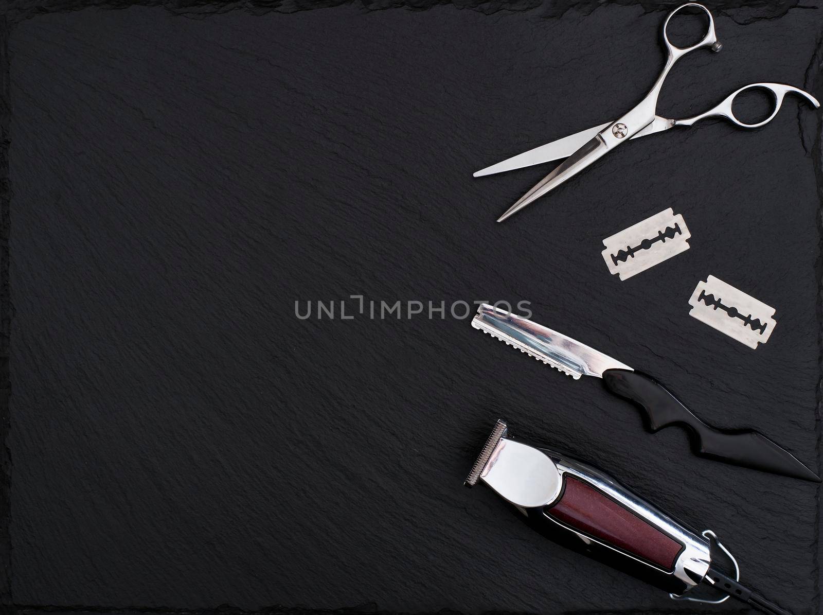 Barber shop equipment on Black background with place for text. Professional hairdressing tools. Comb, scissor, clippers and hair trimmer isolated.