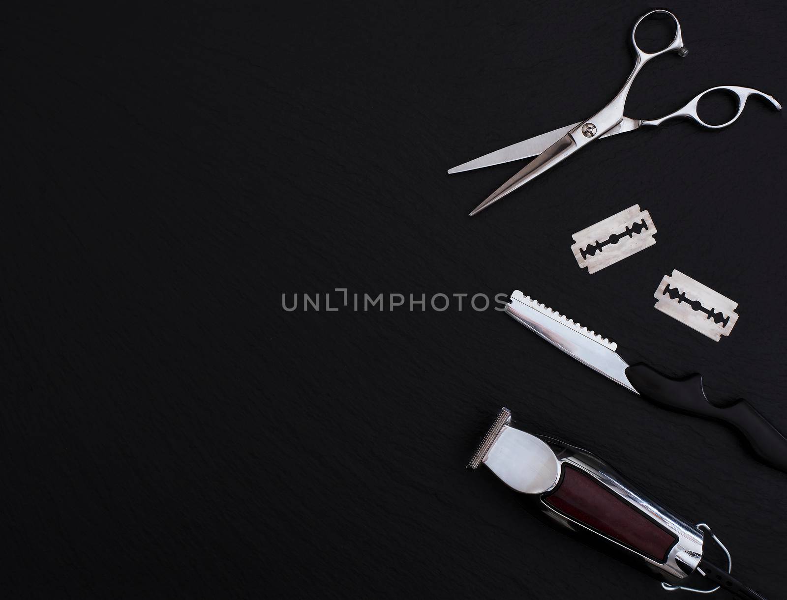 Barber shop equipment on Black background with place for text. Professional hairdressing tools. Comb, scissor, clippers and hair trimmer isolated.