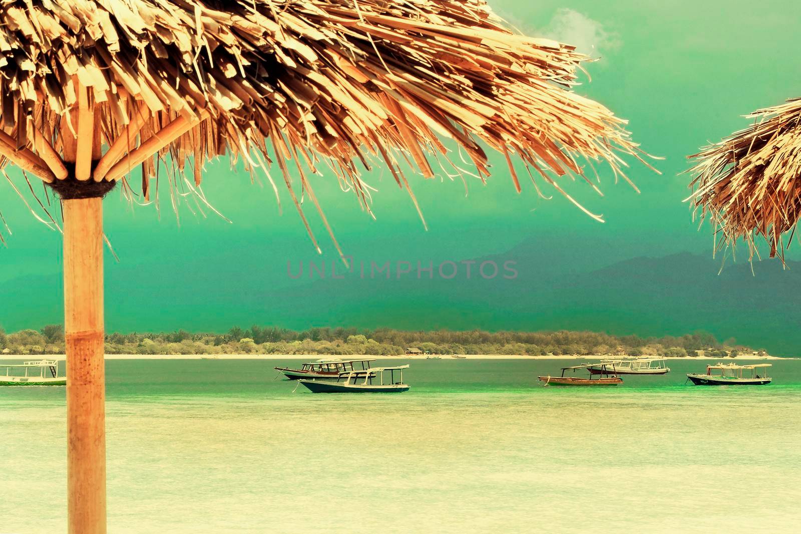 Straw umbrella on a sandy beach in island. by Jyliana