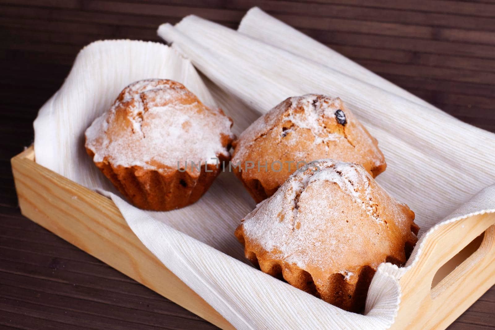 Muffin cakes on a white tablecloth. Stock image.