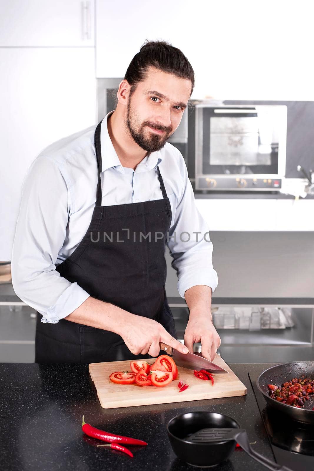 Chef preparing dishes in a frying pan. Cooking. Stock image