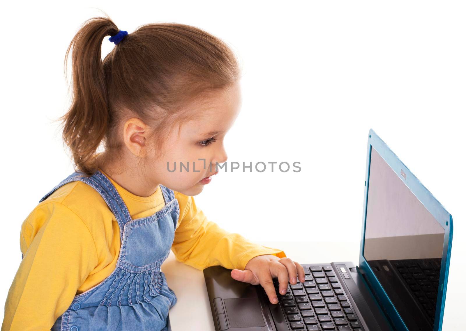 Portrait of a cute little girl using laptop. Horizontal shot. Isolated on white.