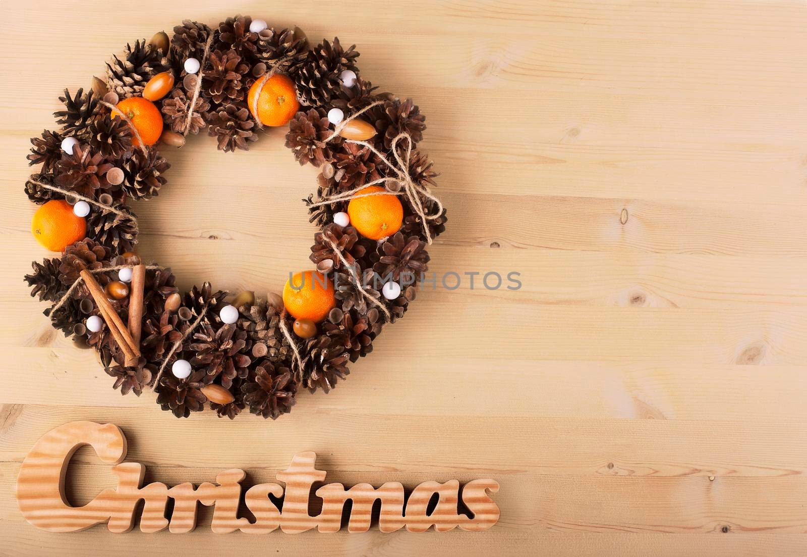 Christmas frame for greeting card with decorative wreath. wooden background