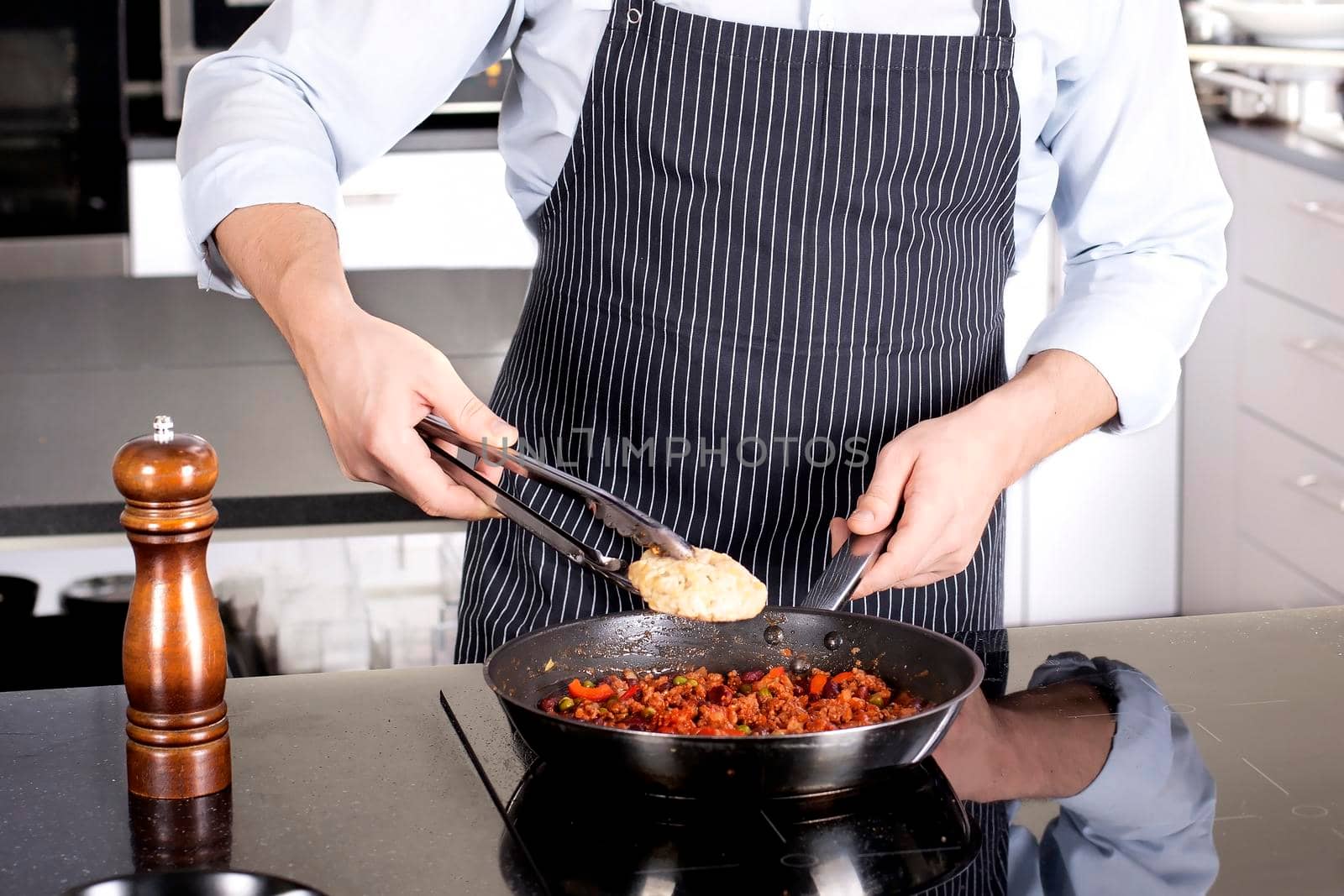 Chef preparing dishes in a frying pan by Jyliana