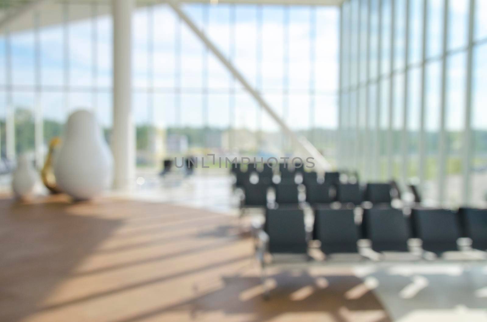 Office building or university library lobby hall reading area blur background with blurry school hallway corridor interior view to empty corridor entrance, glass wall and exterior light illumination