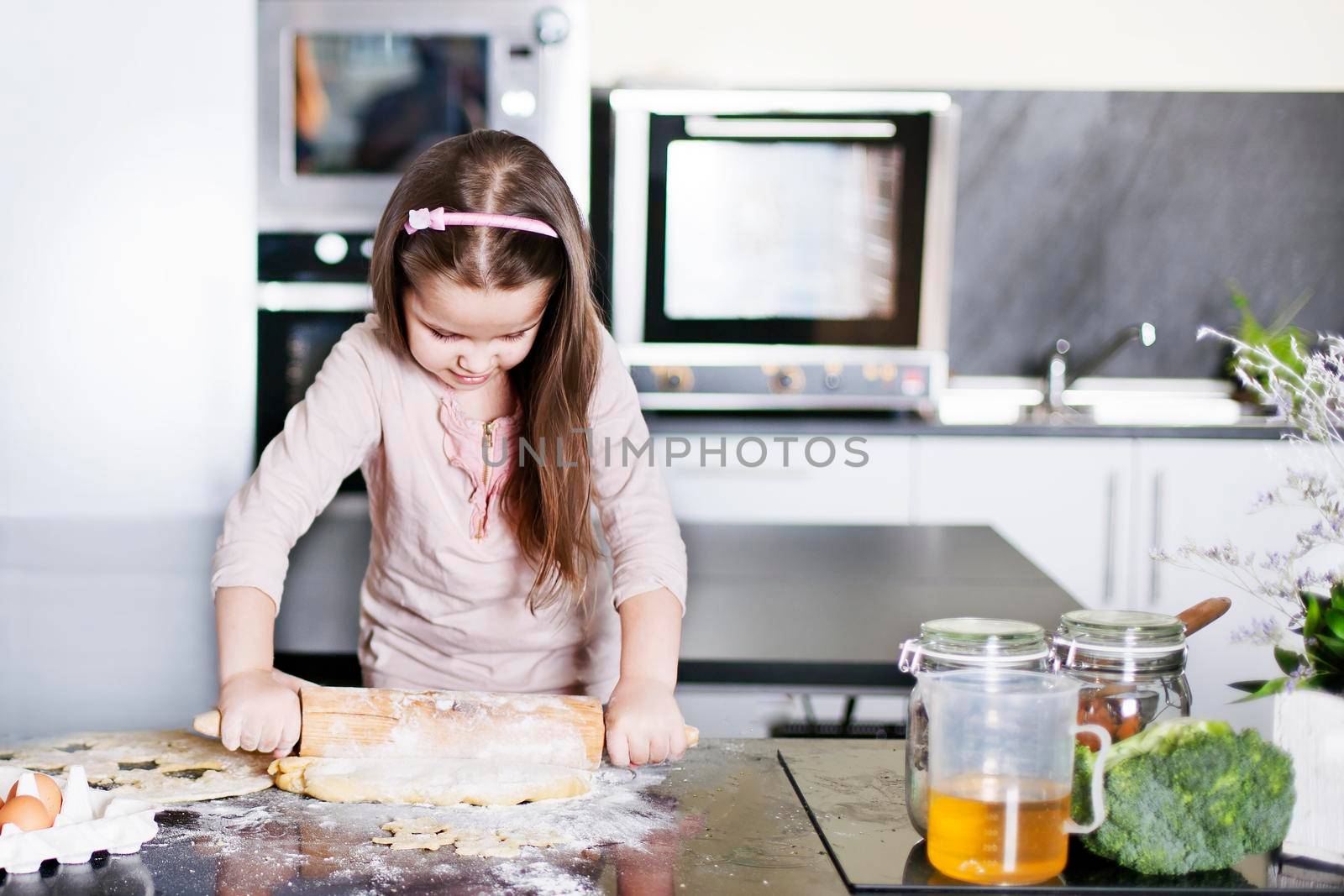 little daughter cooking in the kitchen by Jyliana