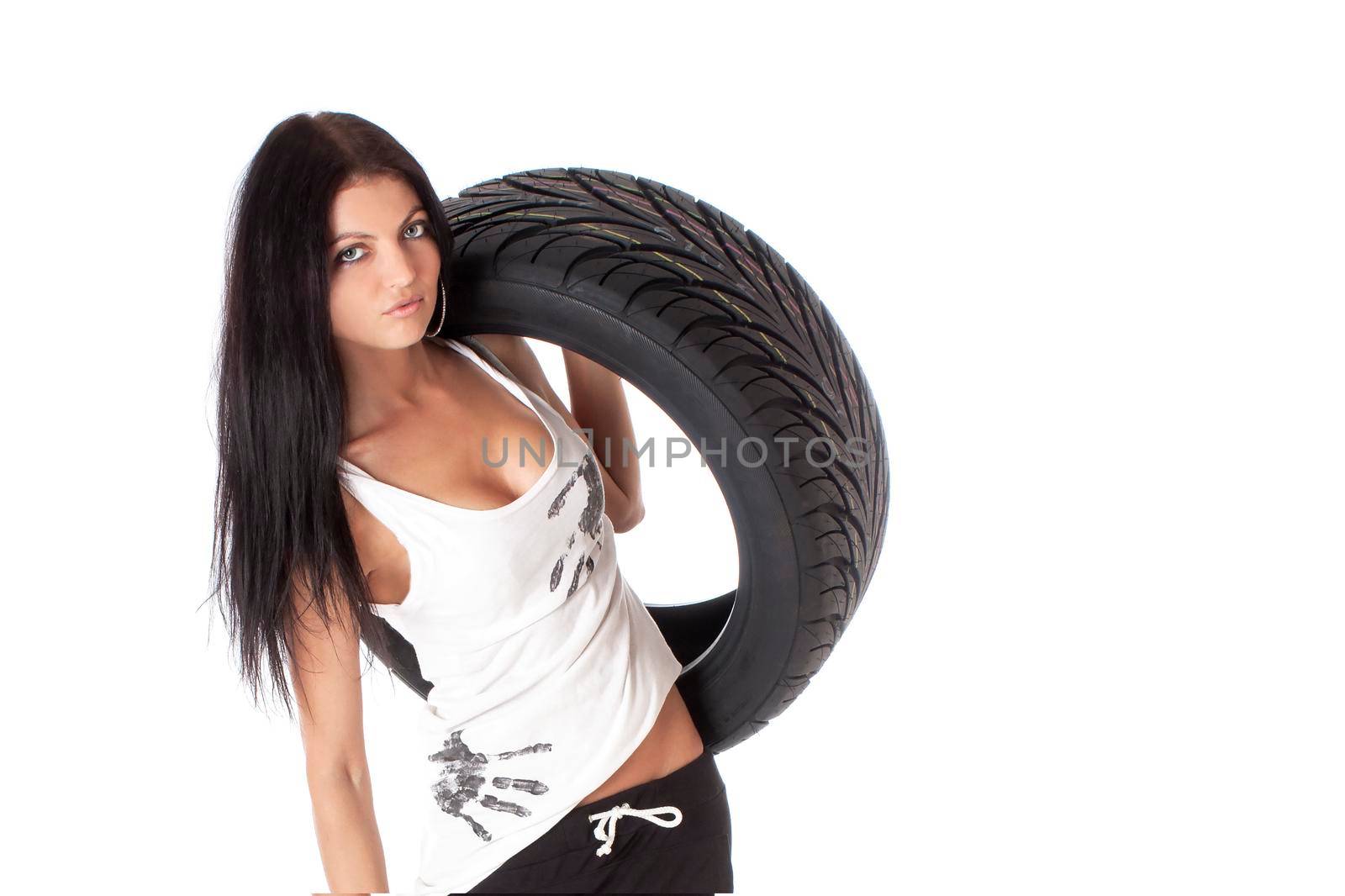 Young sexy girl holding a car wheel, isolated on white.