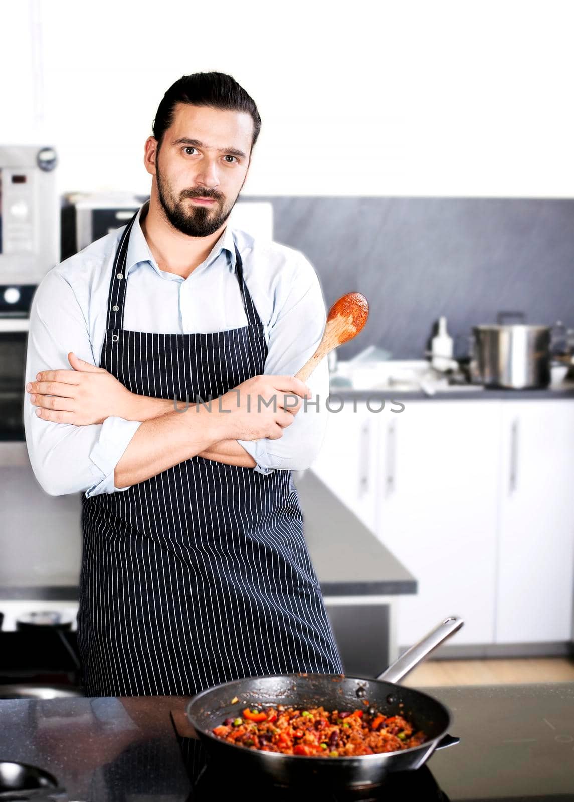 Chef preparing dishes in a frying pan. Cooking. Stock image