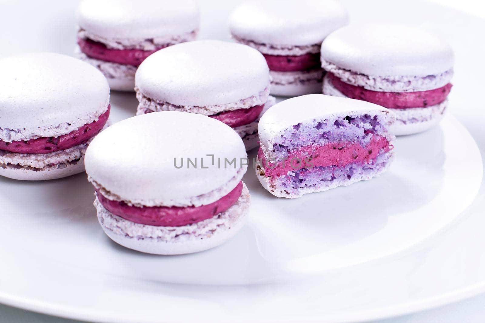 French Macarons with cranberries on blue napkin - Stock image