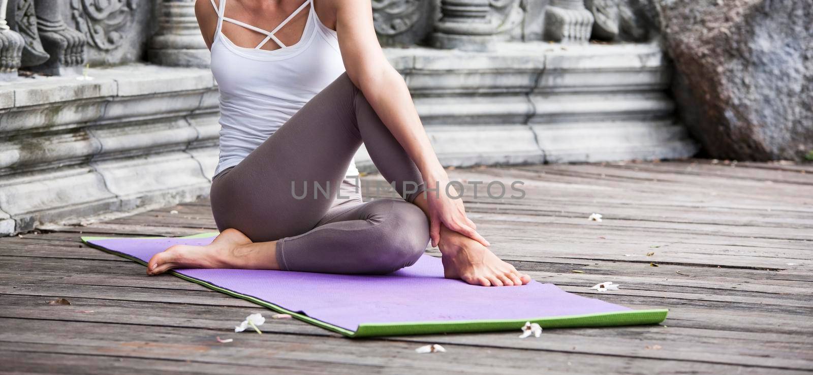 Young woman doing yoga in abandoned temple