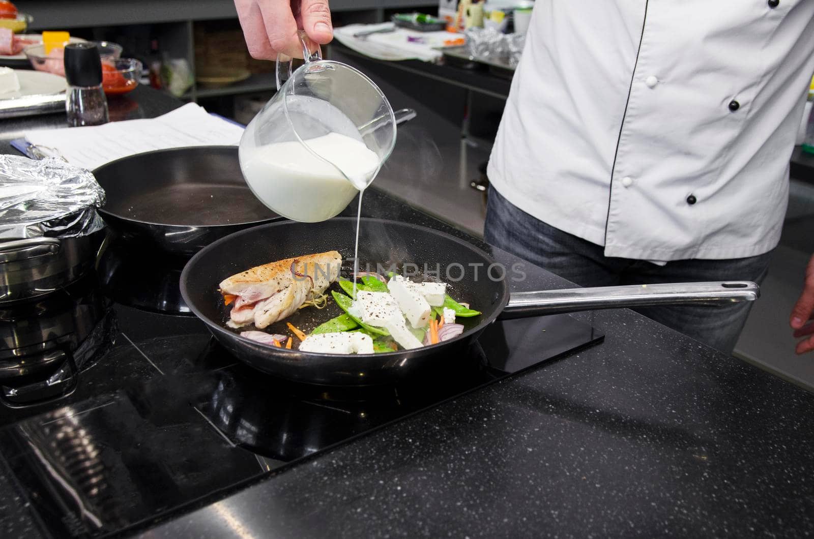 Chef preparing dishes in a frying pan. Cooking. Stock image